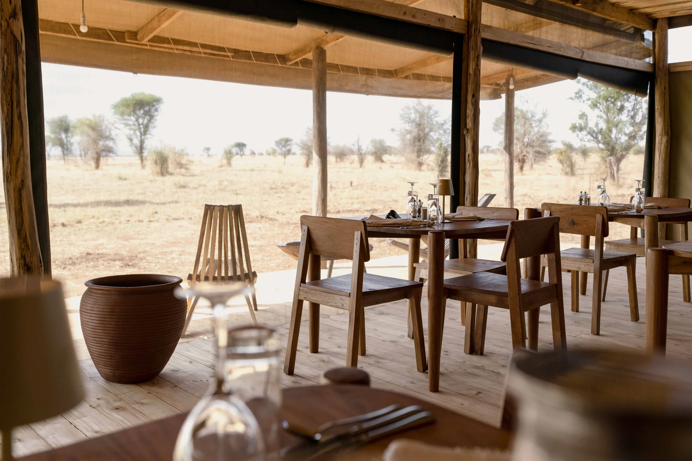 Warm timber dining room looking onto Tarangire